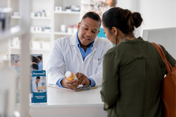 Pharmacist speaking with patient about medicine
