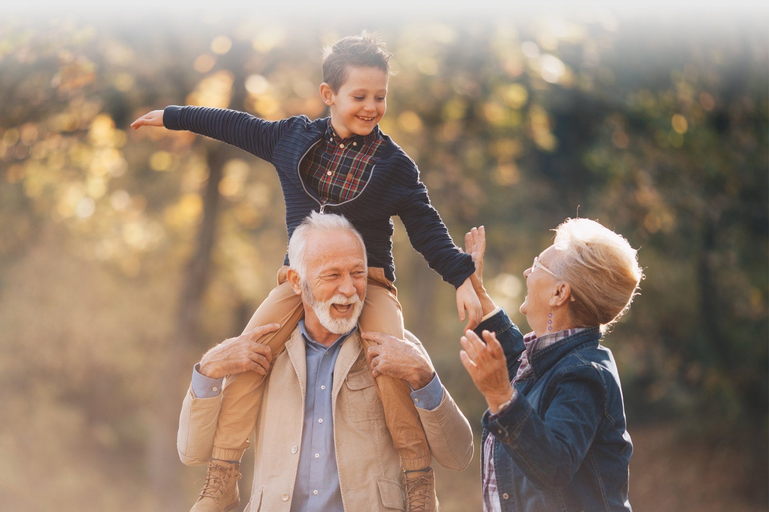 grandfather and grandmother having fun on a walk in the woods with their grandson