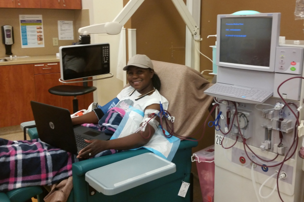 Precious on computer while getting dialysis