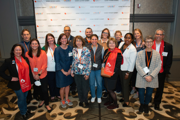 Large group of happy Voices advocates in front of Voices banner