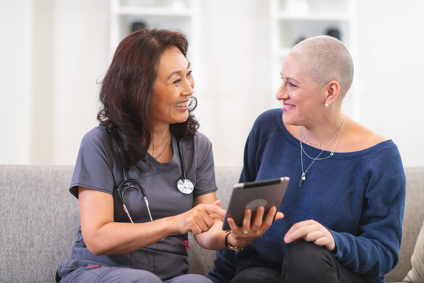 Healthcare professional and patient speaking on couch