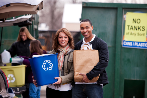 Two people recycling at a recycle center