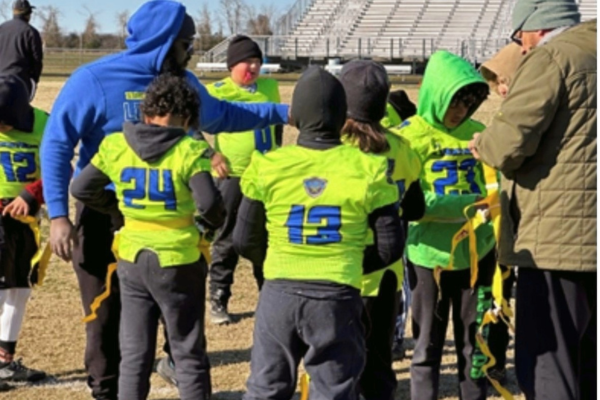 Robert Moore coaching a group of young football players