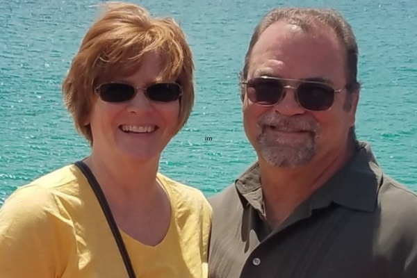 Shelly and Tim smiling with ocean behind them