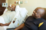 Hospital visitor laughing with patient