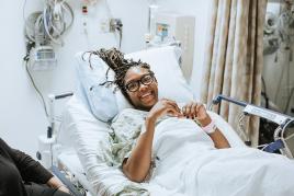 woman looking happy in a hospital bed