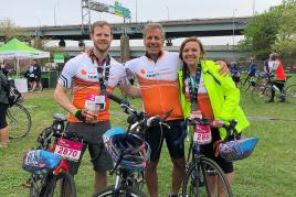 Three cyclists posing before a group NKF fundraising ride
