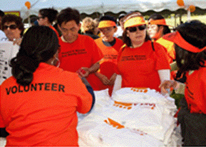 NKF Volunteers at an event wearing "Volunteer" t-shirts