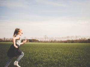 Kid running across a field