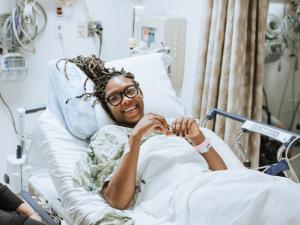 patient smiling in hospital bed