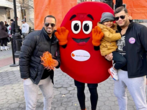 Eliecer Marte, his husband Erick Martinez, their child, and Sydney the Kidney