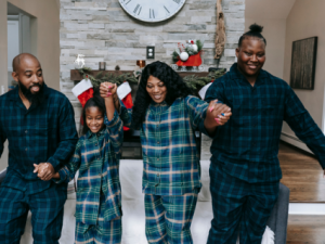 Family in pajamas holding hands