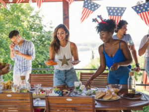 Group of friends setting a table for 4th of July party