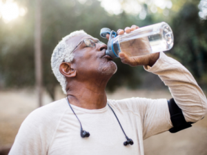 Person drinking water after exercising