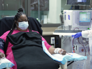 Person receiving dialysis treatment in center