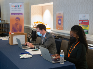 Two people at kidney summit typing