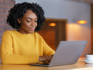 young businesswoman typing on laptop sitting