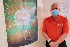 Mike Crowley in hospital with transplant hospital display showcasing his name