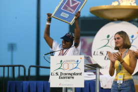 Winner of Transplant Games holding their trophy