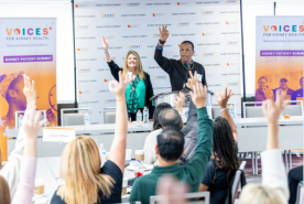 Kidney patient summit breakout session with people raising their hands