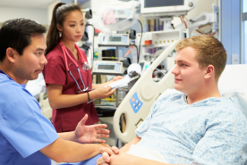 Patient in hospital bed receiving consultation 