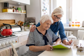 Adult child helping parent with paperwork