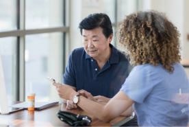 Patient reading paperwork with professional