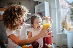 adult and child making a smoothie