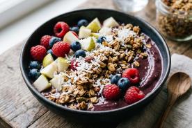 Acai Bowl with berries, chopped pear, granola, and coconut flakes