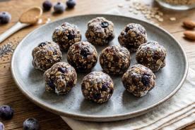Handmade energy balls made with frozen blueberries, oats, almond butter, and dates
