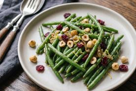Crisp green beans tossed with toasted hazelnuts, sweet dried cranberries, shallots, and lemon zest.