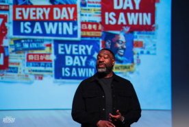 David Rush on Stage with every day is a win banner