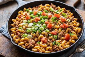Skillet with ground turkey, macaroni, scallions, peppers, and tomatoes