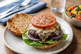 Grilled portobello mushroom burger with swiss cheese with tomato, lettuce, red onion and whole wheat bun