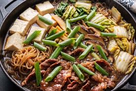 Japanese-style Beef Sukiyaki with tofu, noodles, shiitakes, cabbage and scallions