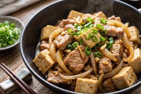 Japanese-style sauteed pork, tofu, onion dish with scallions