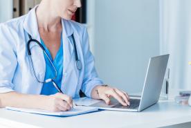 healthcare professionals doing research on laptop