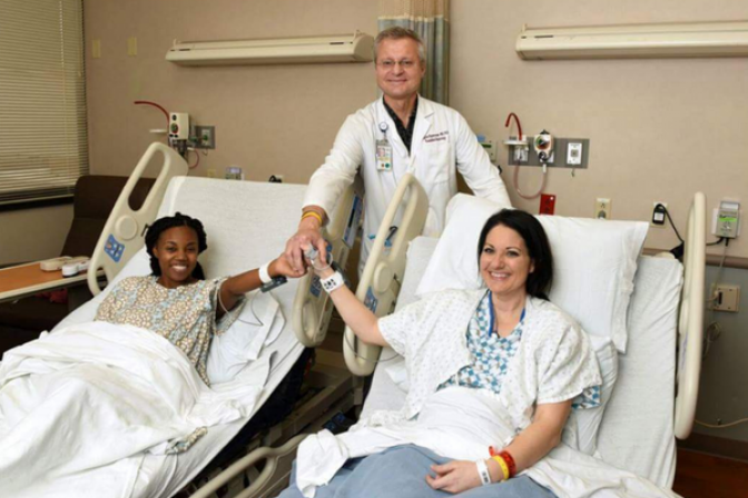 Stephenie, Chané, and transplant surgeon holding hands after surgery