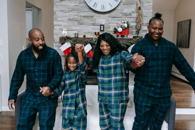 Family in pajamas holding hands