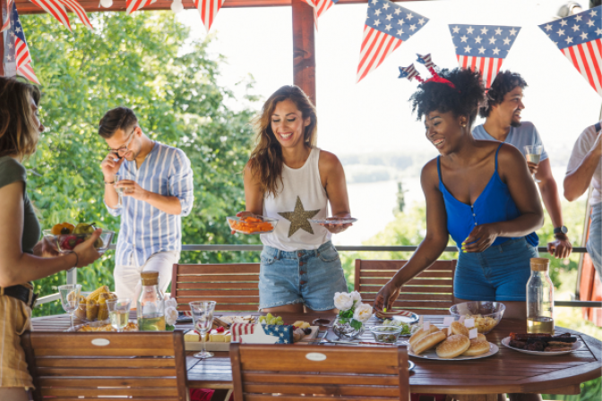 Group of friends setting a table for 4th of July party