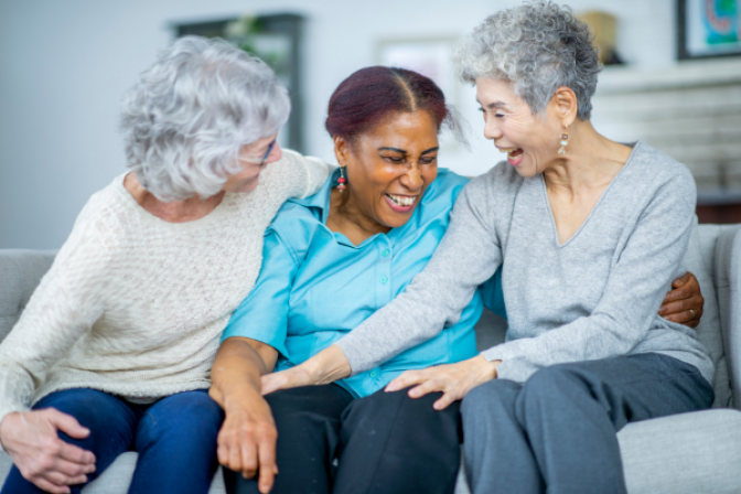 Three older adults laughing together