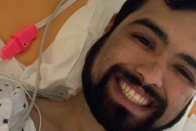 Mario smiling in hospital bed after kidney transplant surgery