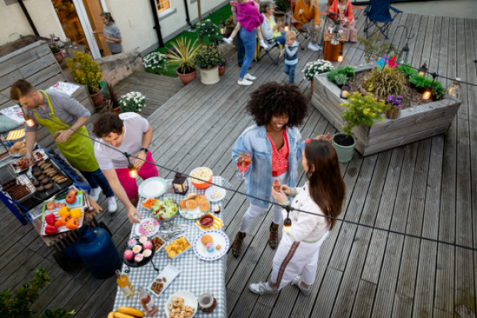 group of people chatting on a deck during a bbq