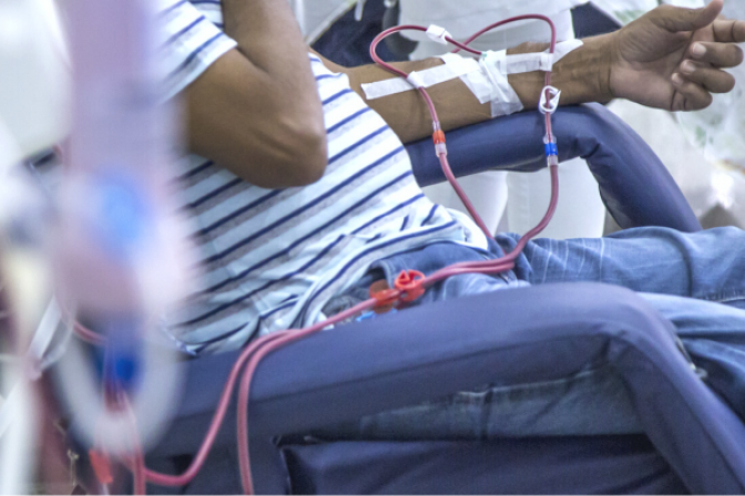 Person hooked up to dialysis machine in center