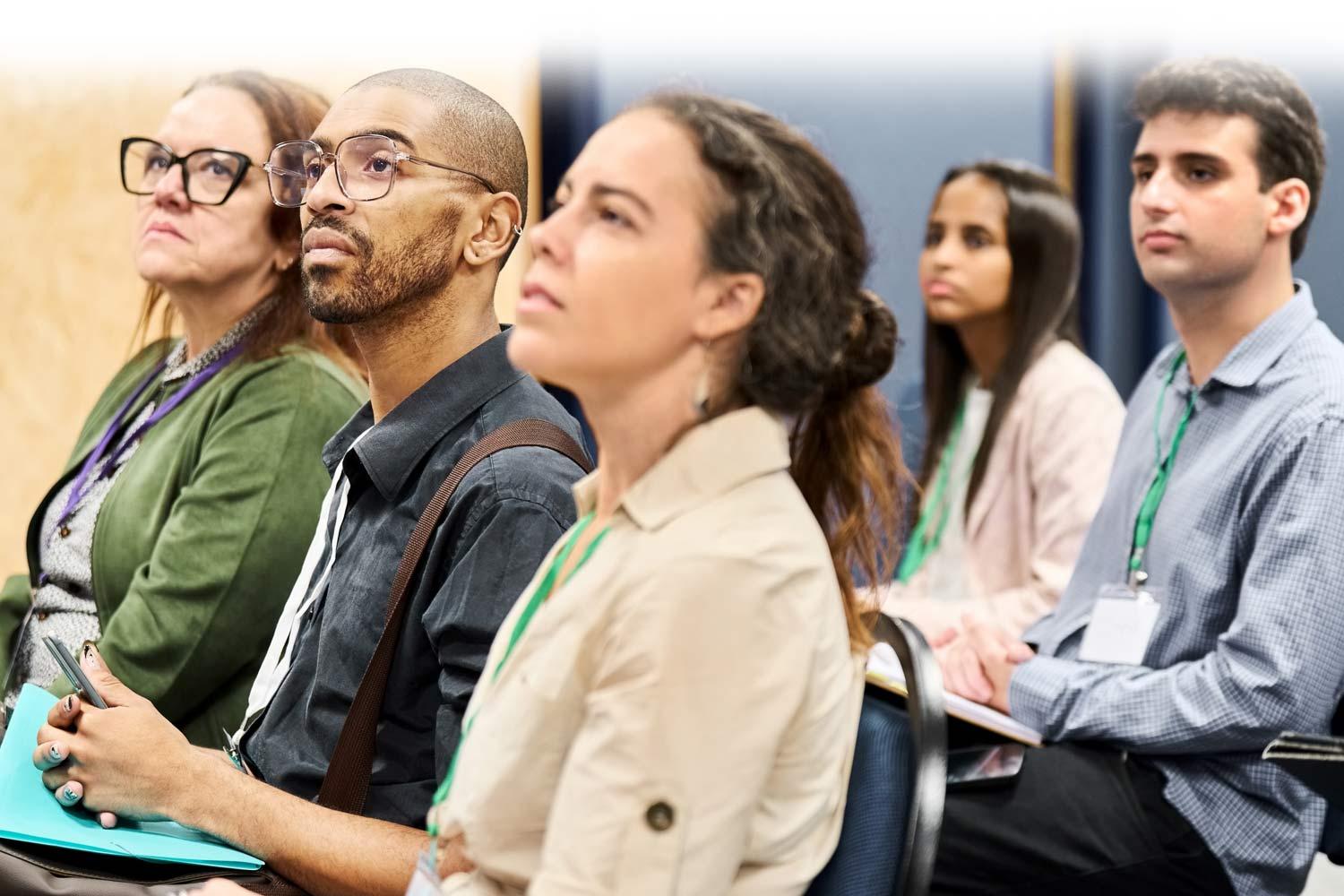 people listening to a speaker