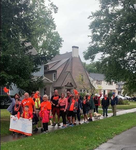 Group of people on the side walk participating in a kidney walk