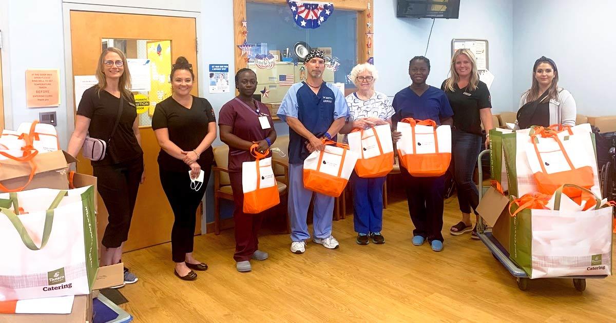 A group of people dropping off Drive for Dialysis bags at a Dialysis Clinic