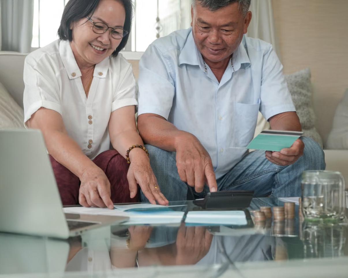 Man and woman sitting on a couch and reviewing paperwork
