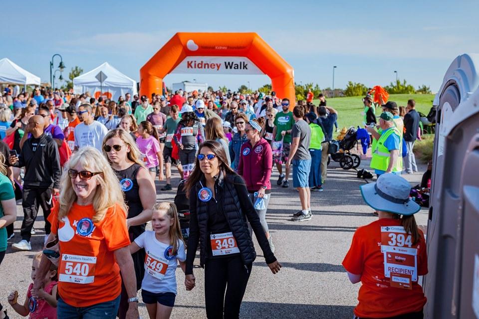 Group of people walking through Kidney Walk banner