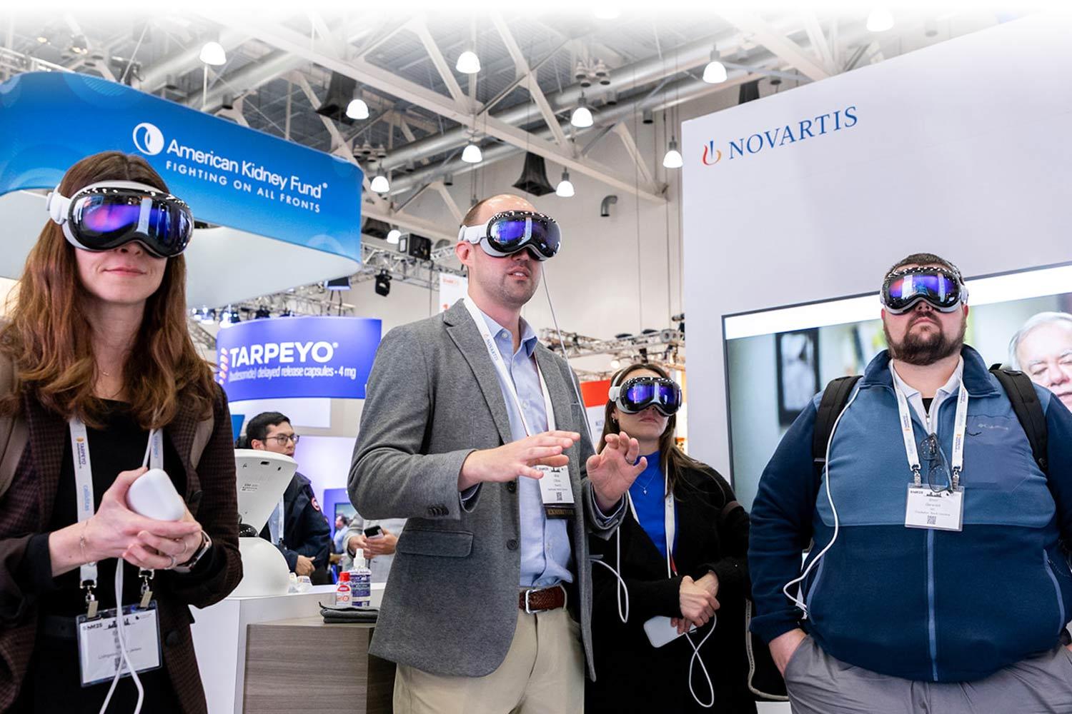 People using Virtual Reality headsets among booths at SCM25